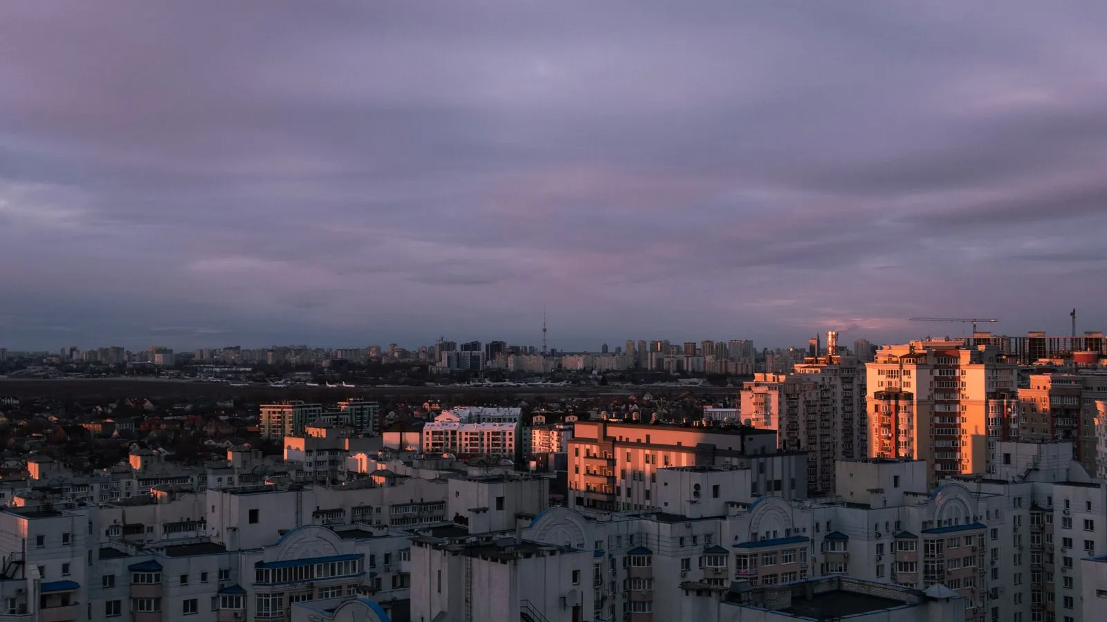 Residential tower blocks of Kyiv under a heavy violet evening sky — file stock photo, not taken on the night of the 22 October strikes, no people