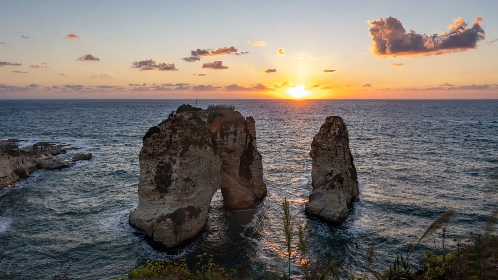 The sun setting over the Mediterranean behind the Pigeon Rocks off Beirut — file stock photo, not taken in southern Lebanon or on the Blue Line, no people